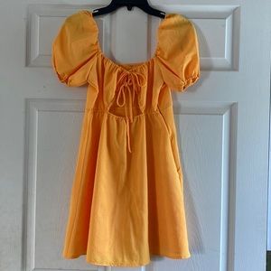 Mini orange dress with puff sleeves! Size 0 with adjustable bow in the front!